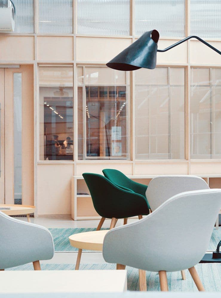 Bright studio office with white chairs and floor lamp