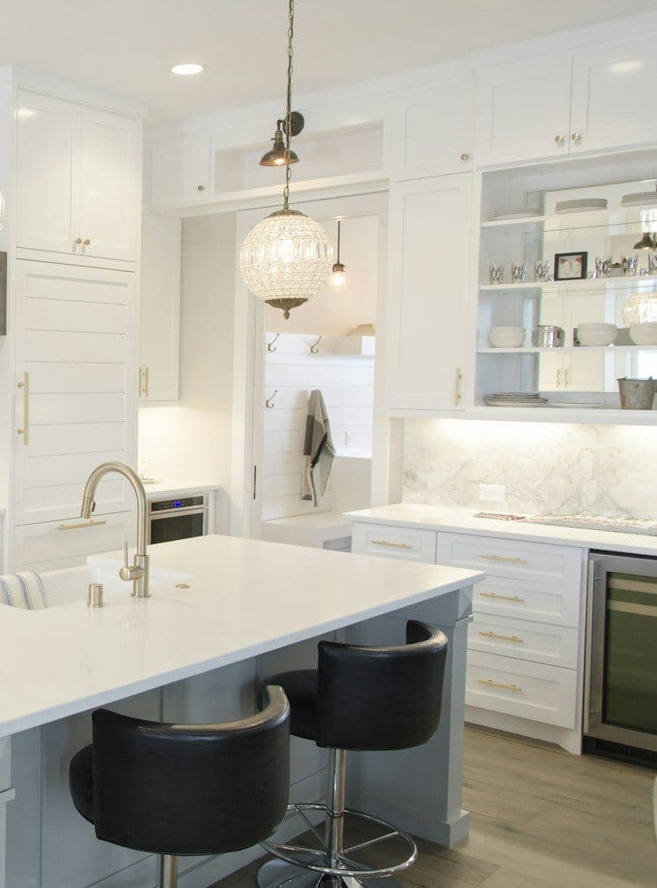White kitchen with glass pendant lights