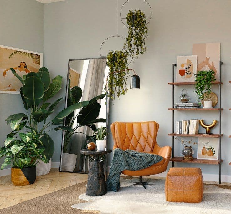 Living area styled with plants and orange chair