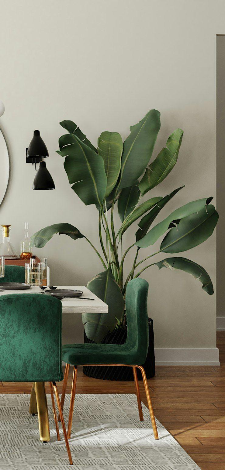 Dining room with green velvet chairs and round mirror