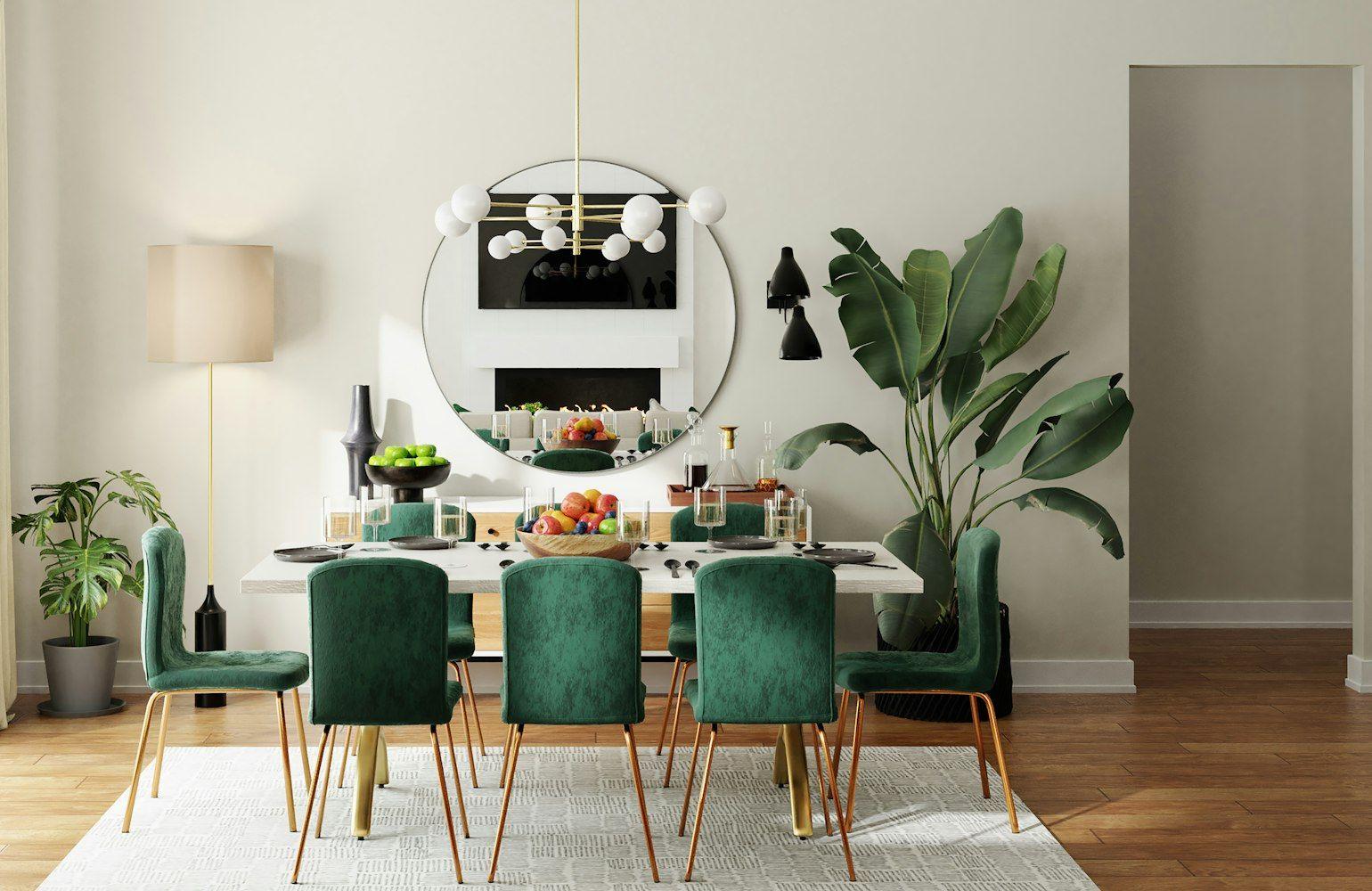 Dining room with emerald chairs and statement pendant