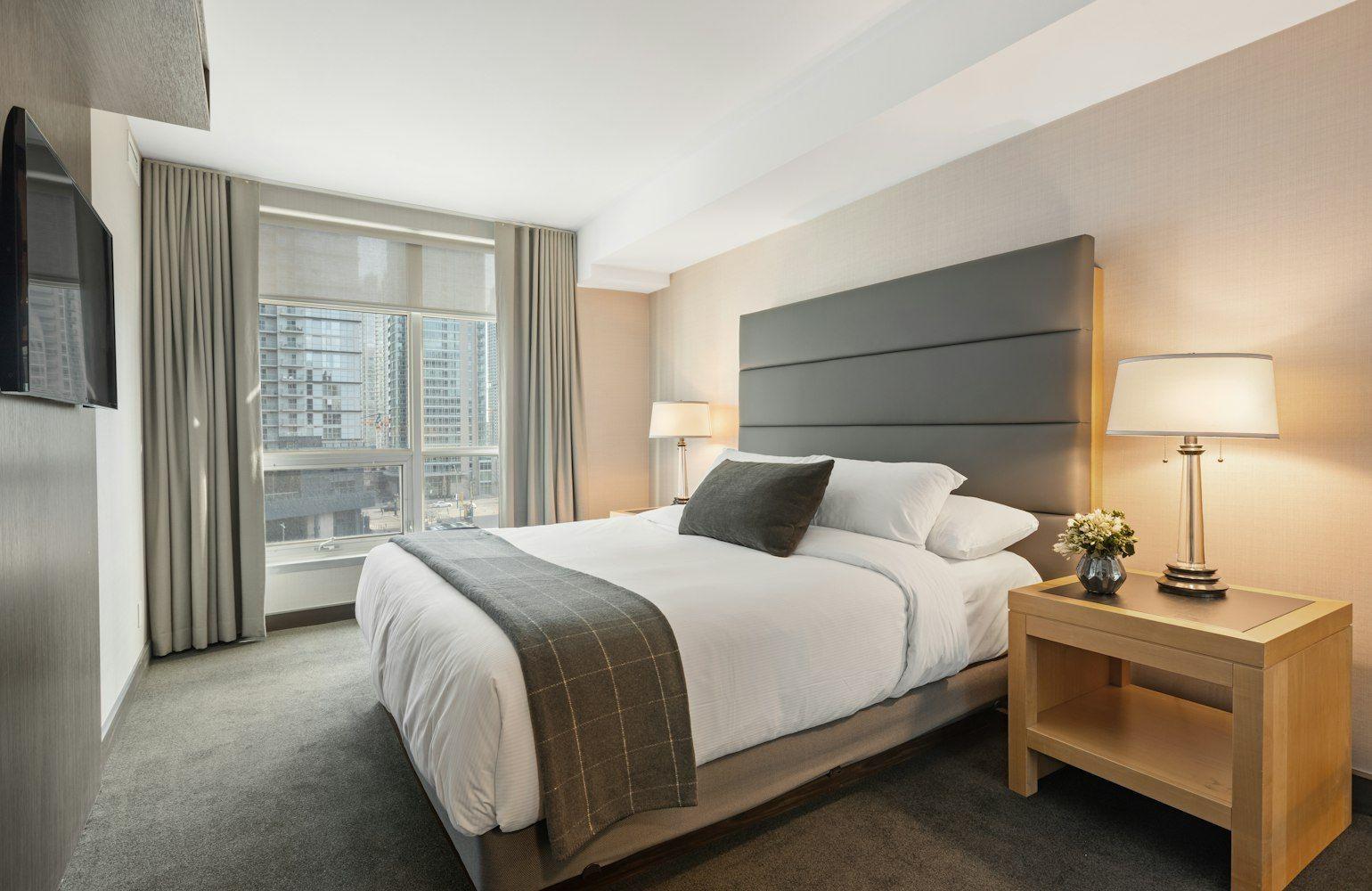 Hotel-style master suite with full-height headboard
